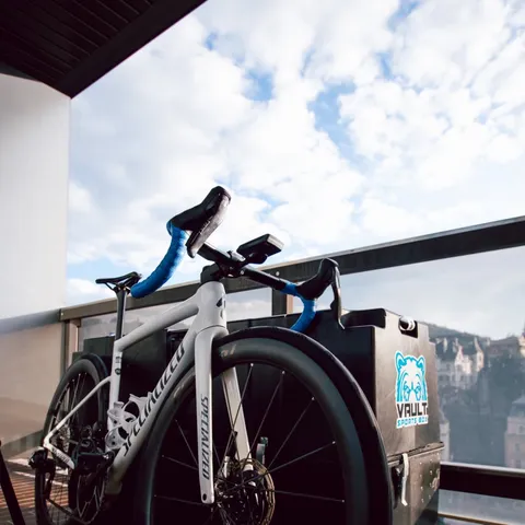 Erika Ackerlund's Specialized road bike leaning on her Vault Pro