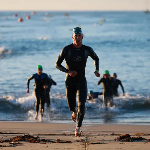 Joshua Berles running out of the sea, first professional out of the water at IRONMAN 70.3 Santa Cruz 2025