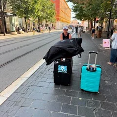LaRee Holcomb with her Vault Sports Box and luggage on a city street