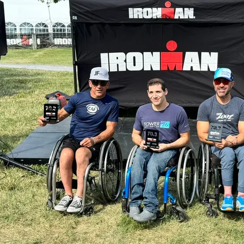 Rob Balucas on an IRONMAN podium with two other wheelchair athletes