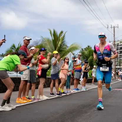 Sam Long running past cheering spectators in Kona